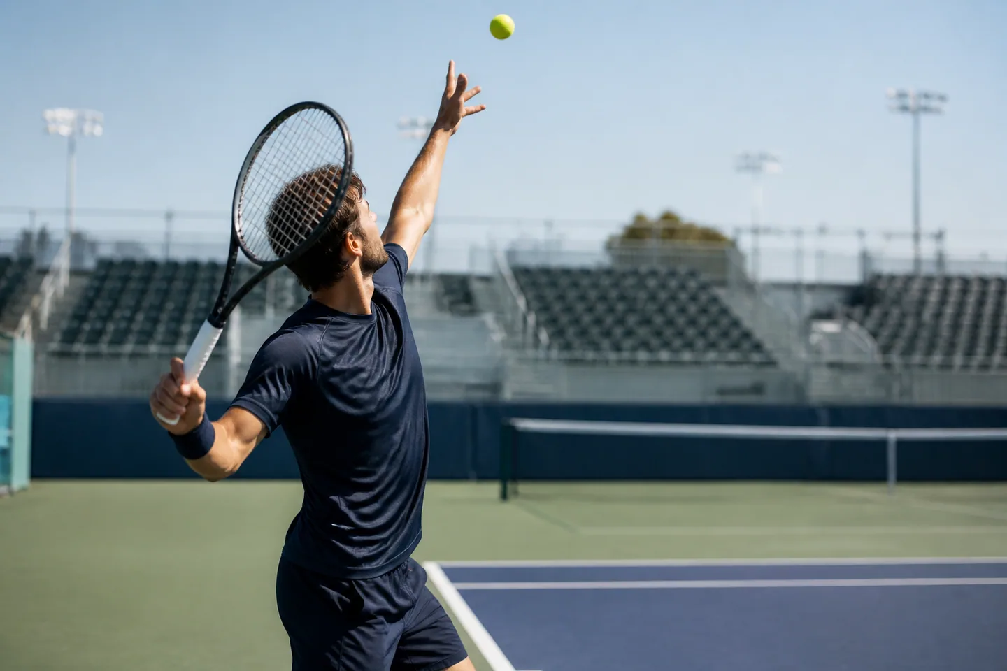 Tennis player preparing to serve on a practice court