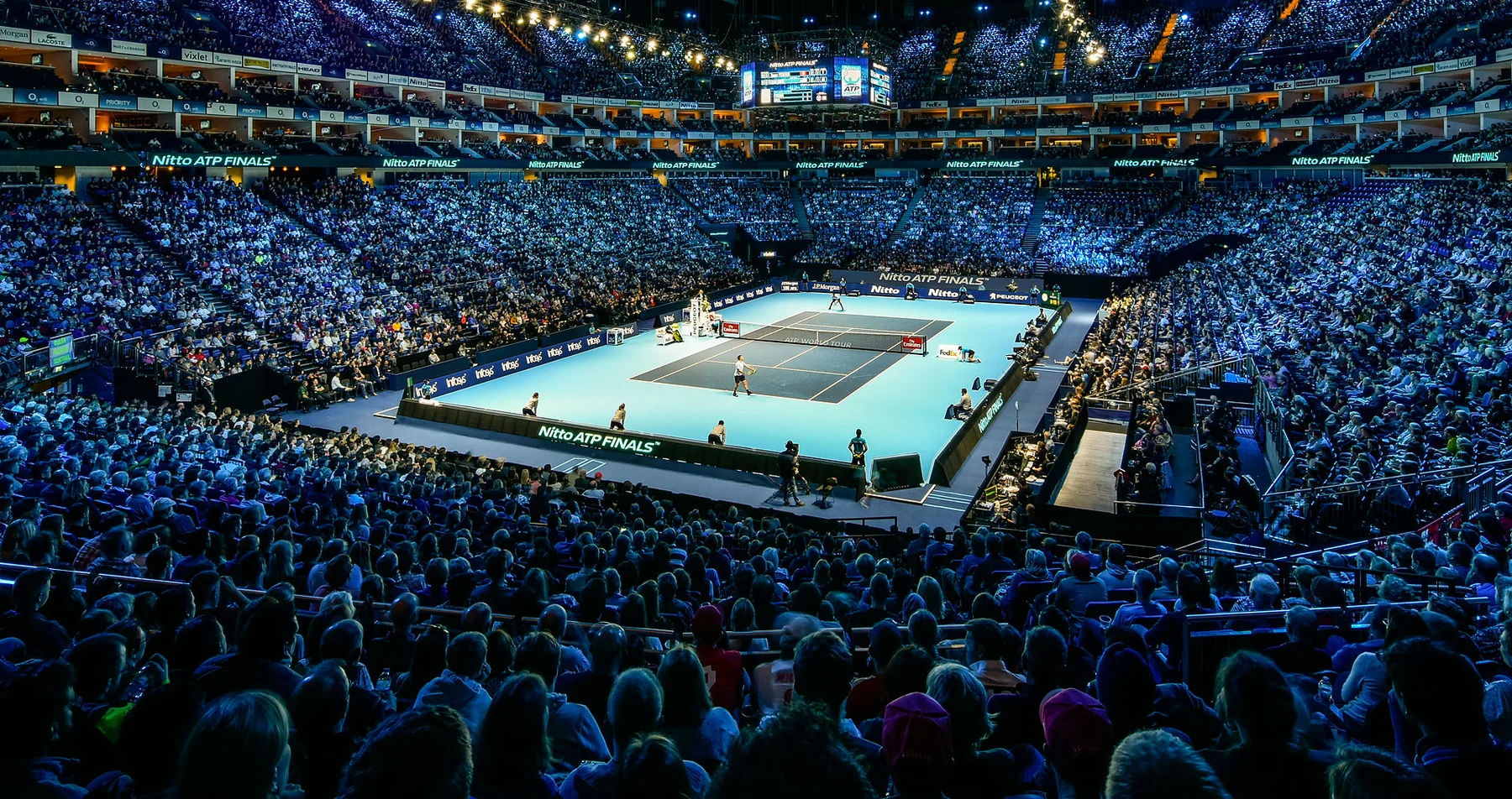 A wide view of an indoor Nitto ATP Finals match and the arena crowd