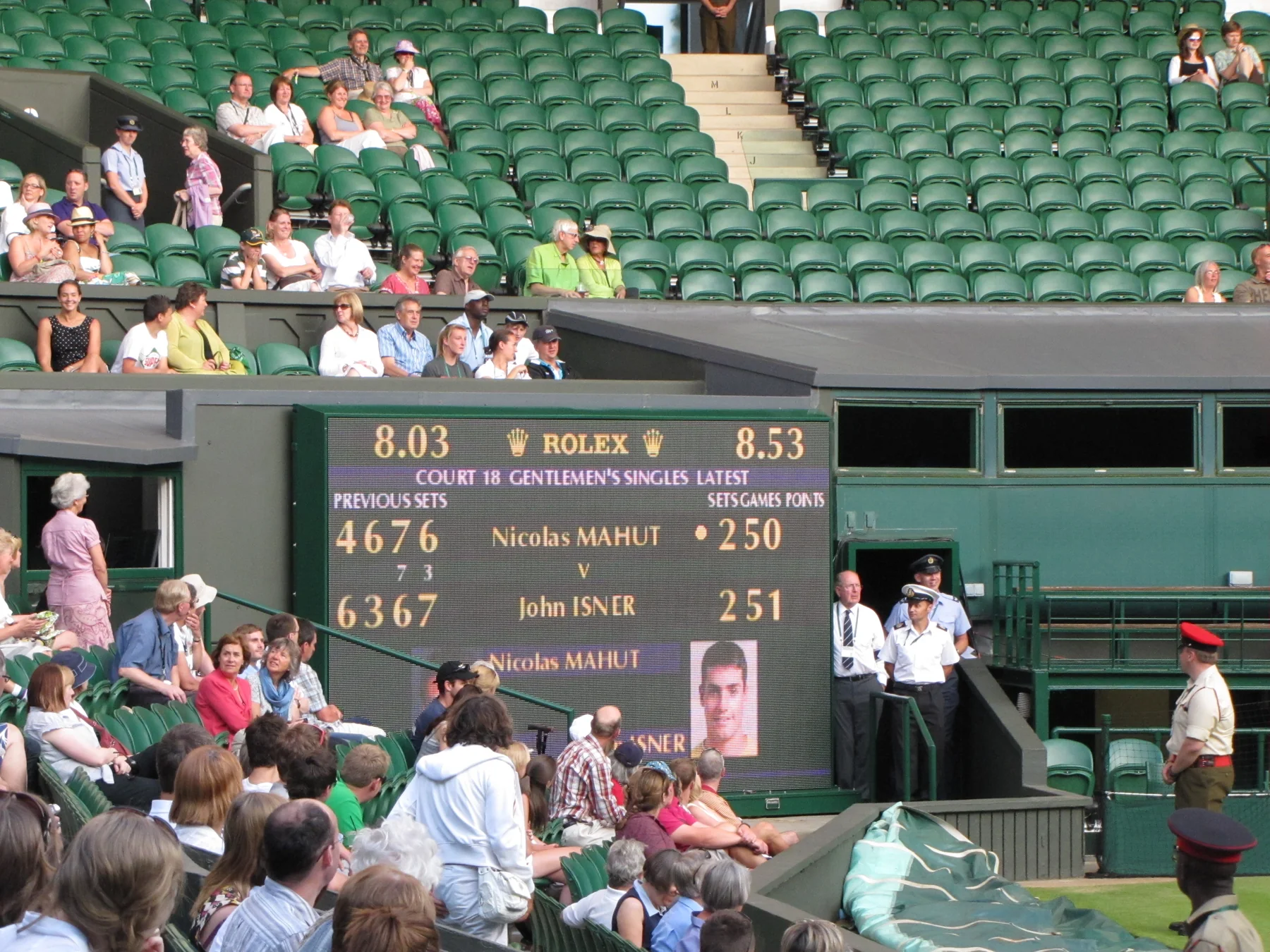 Tennis court and scoreboard during a live tournament session