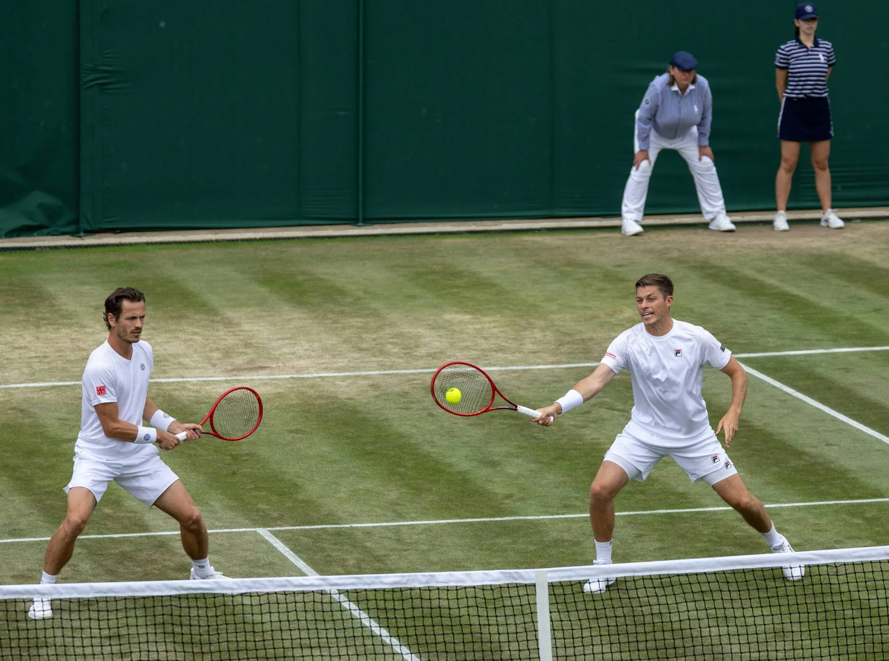 Neal Skupski and Wesley Koolhof playing men's doubles on grass at Wimbledon