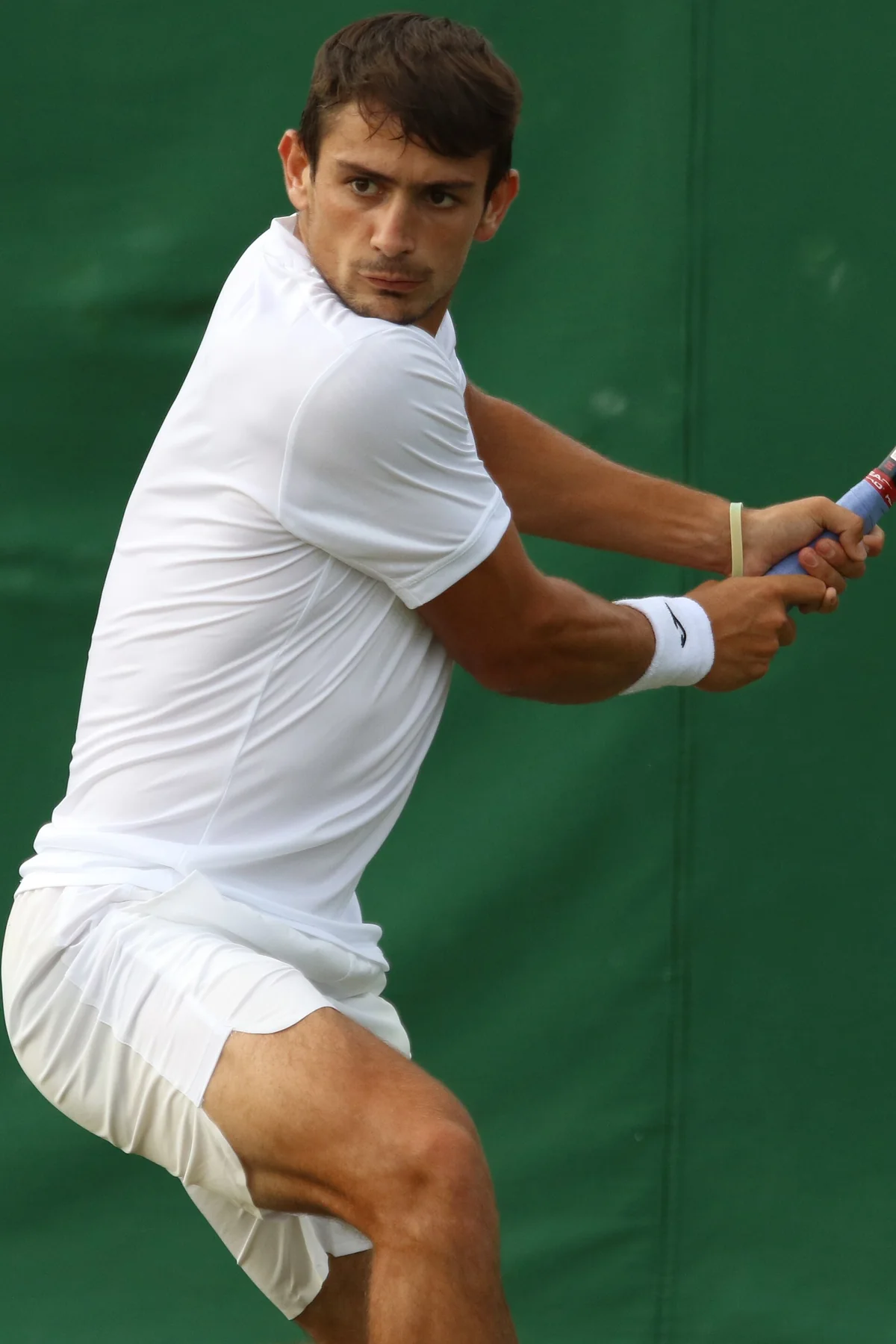Mariano Navone preparing to strike a tennis ball